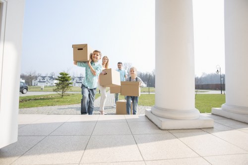 Removal team preparing a home move in Sutton with packed boxes and furniture