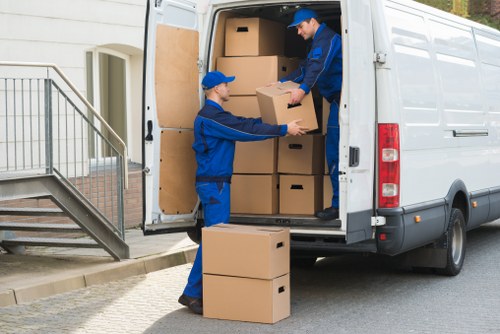 Professional movers loading furniture from a Sutton property