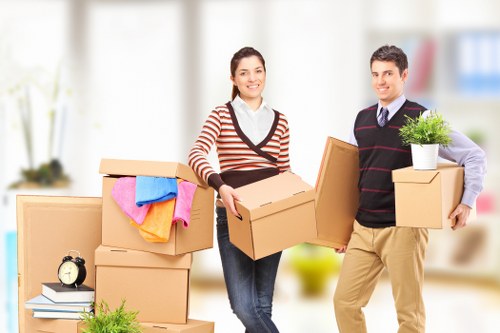 A moving helper loading household items into a van