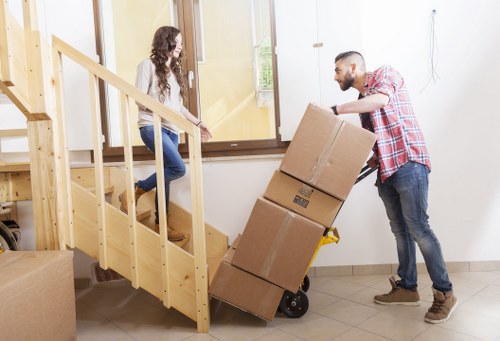 Packed moving boxes and furniture prepared for a Sutton home move