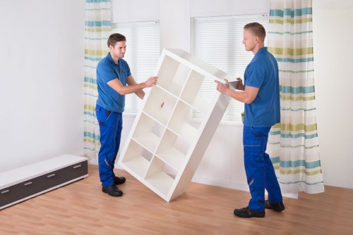 Local removal team unloading boxes and furniture at a new Sutton home